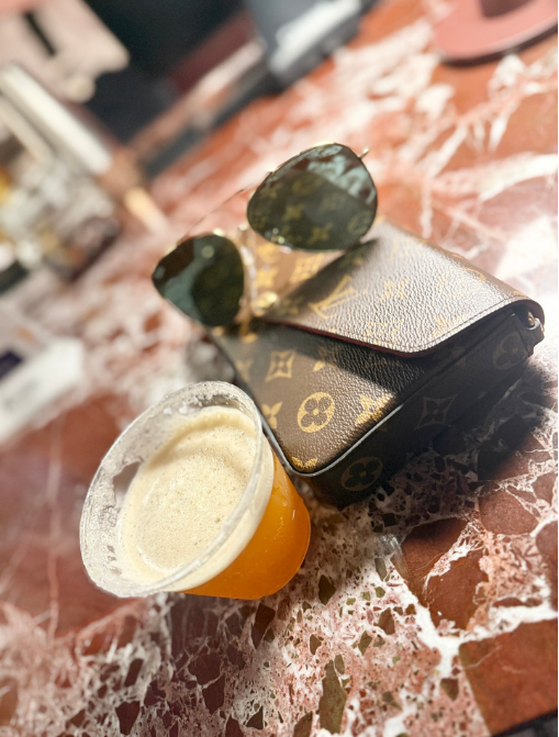 Luxury wallet, sunglasses and craft beer flight — lifestyle product shot