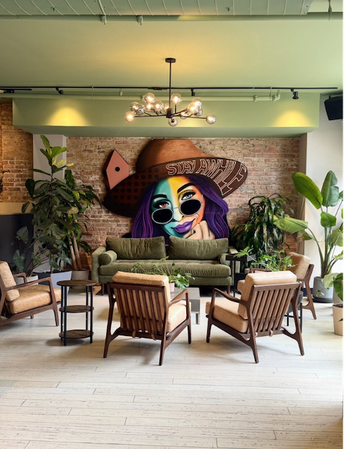 Funky restaurant lounge with mural and mid-century seating