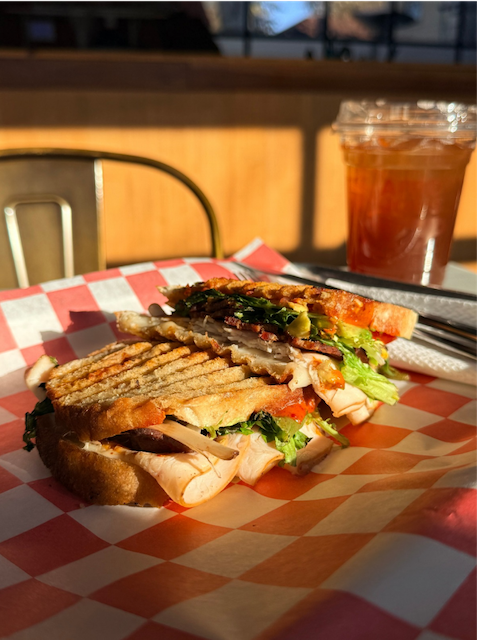 Grilled turkey panini with iced tea — casual food photography