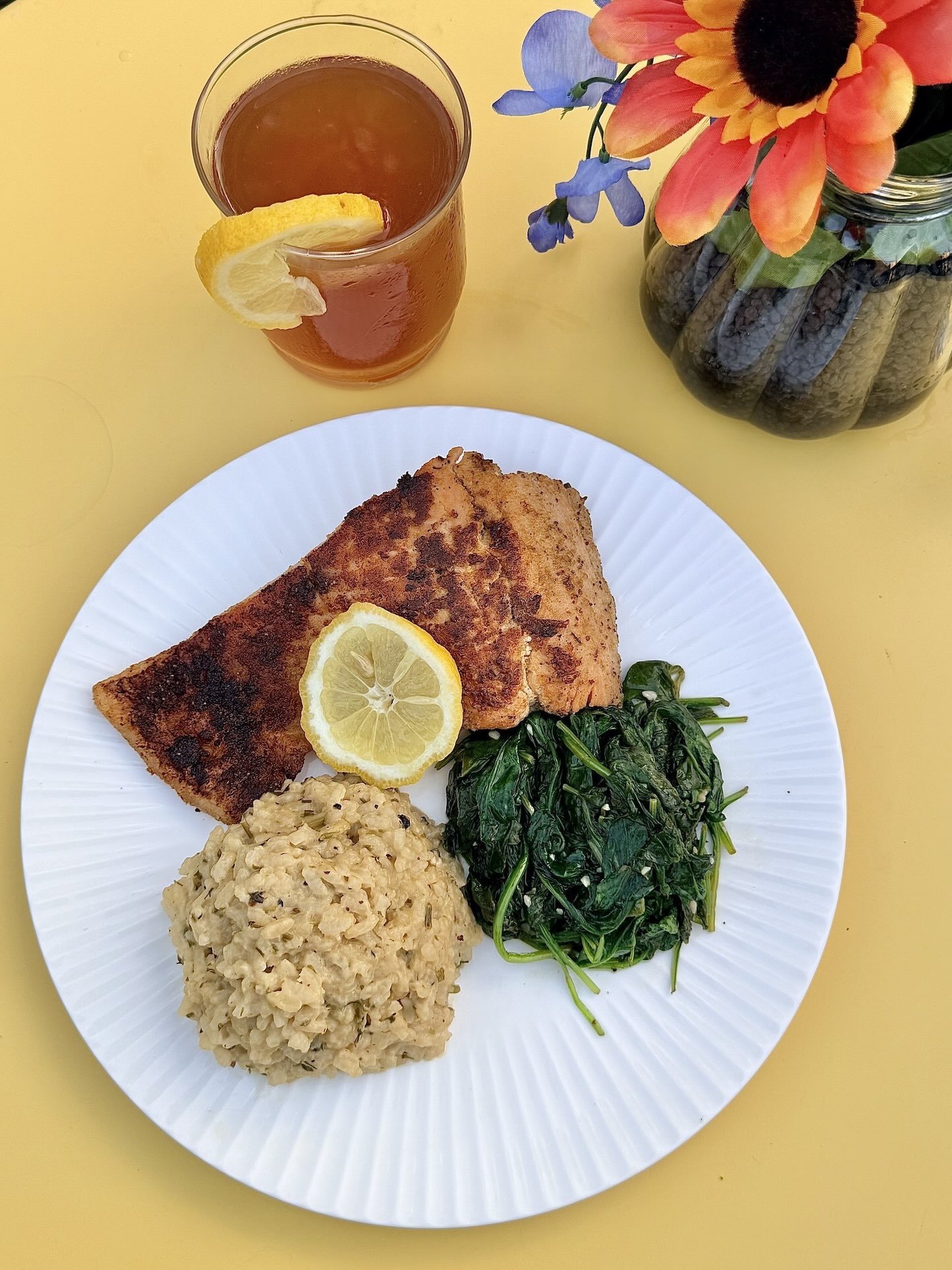 Deckside with Ceva — blackened salmon plate with risotto, sautéed spinach, and iced tea